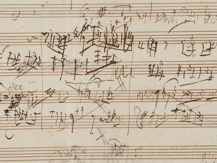 Handwritten musical notation with various markings and annotations. The image showcases a creative process, highlighting revisions and ideas in composition.